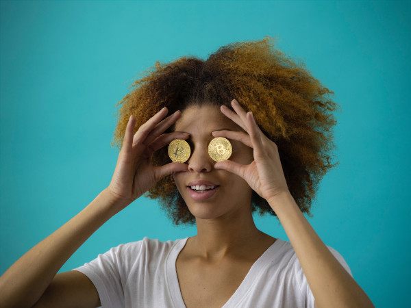 woman with two bitcoins over her eyes