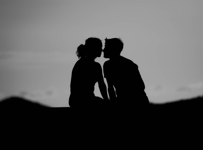sihouette photo of man and woman about to kiss