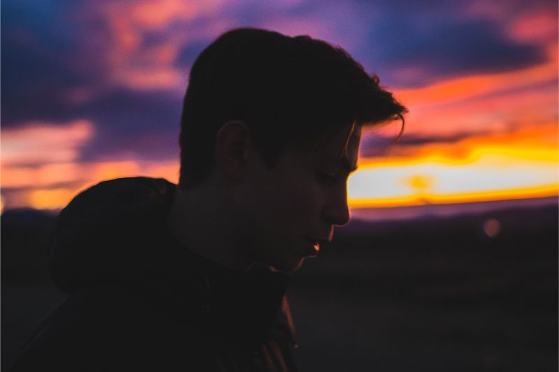 a young man with sunset